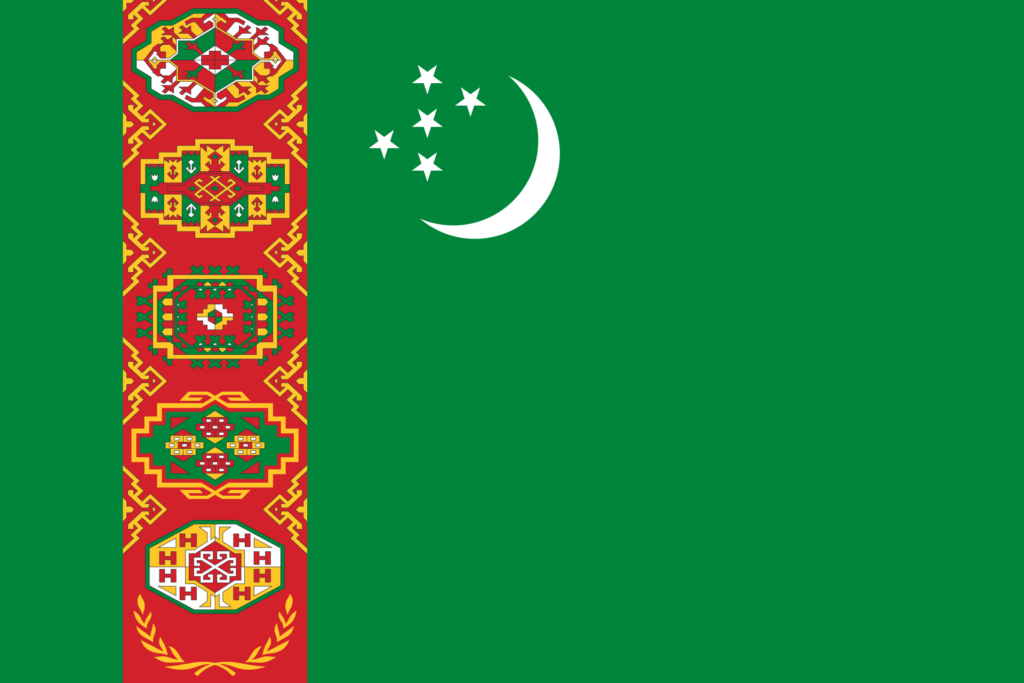 Flag of Turkmenistan featuring a green field with a vertical red stripe near the hoist side containing five carpet guls stacked above two crossed olive branches, and a white crescent moon and five white five-pointed stars to the right.