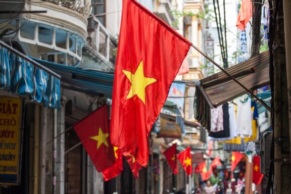 Vietnamese flags hanging above a street in Hanoi.