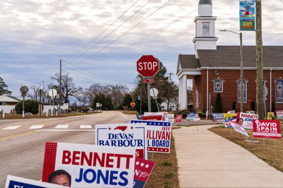 Signs line a sidewalk in Selma, North Carolina, one of the 2024 swing states.