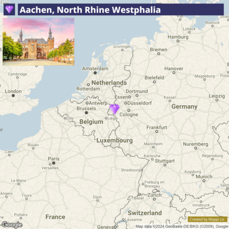 Map highlighting the location of Aachen in North Rhine-Westphalia, Germany, with a small photo of a historic building in Aachen at the upper left corner and a purple diamond shape indicating the city's position on the map.