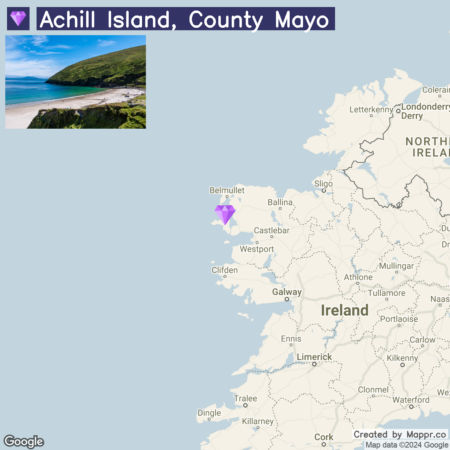 A graphic image showing a map of Ireland with a marker indicating the location of Achill Island in County Mayo. To the upper left, there is an inset photo of a coastal scene presumably from Achill Island, depicting a sandy beach with lush green hills in the background. The title "Achill Island, County Mayo" is displayed at the top.