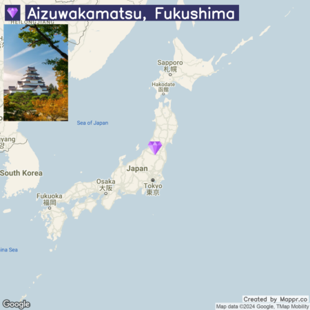 A map highlighting the location of Aizuwakamatsu, Fukushima in Japan, with an inset photo of a traditional Japanese castle surrounded by autumn foliage.