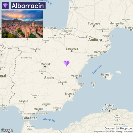 Map of Spain highlighting the location of Albarracin with an inset photo of the town at sunset in the top left corner. The purple diamond symbol marks Albarracin's location on the map, which is to the east of Madrid and south of Zaragoza.