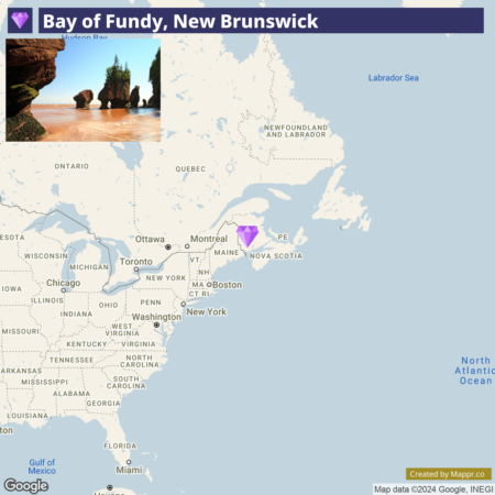 An infographic with a map of the northeastern United States and southeastern Canada, highlighting the location of the Bay of Fundy in New Brunswick with a purple marker. The upper portion of the image displays a scenic photo of the coastline at the Bay of Fundy featuring rock formations and reddish-brown water under a blue sky. Text on the image reads "Bay of Fundy, New Brunswick." There is a Google attribution and a note saying "Created by Mappr.co" at the bottom.