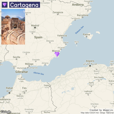 A digital map showing a marked location pin over Cartagena in Spain, with the country and surrounding areas like Madrid, Barcelona, and the Balearic Sea visible. The inset in the top left corner shows an ancient Roman theatre with a modern city in the background.