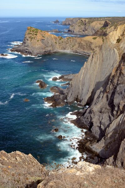 Dramatic and colorful cliffs at praia da arrifana arrifana beach