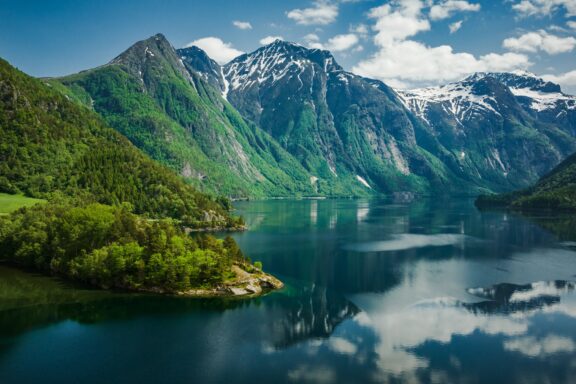 Eikesdalsvatnet's tranquility, serene waters cradled by towering mountains