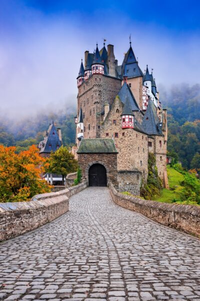 Elz Castle Surrounded by Autumn Foliage The enchanted Eltz Castle admist the woodsFreudenberg's uniform beauty