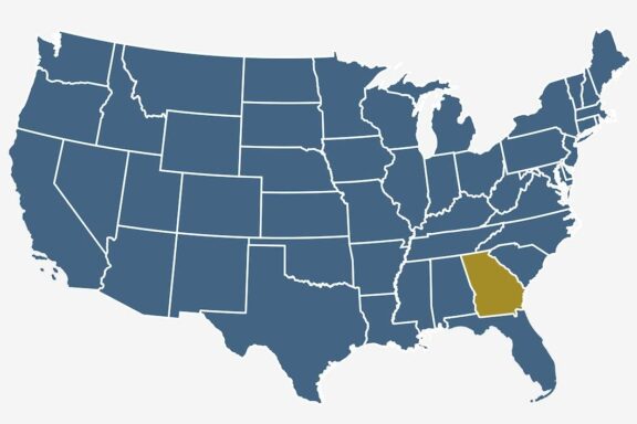 A simplified map of the United States with each state delineated by borders, and the state of Georgia highlighted in gold.