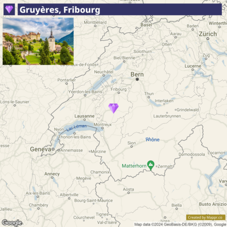 A screenshot of a map highlighting the location of Gruyères in the Fribourg region of Switzerland with a small inset photo at the top left showing a scenic view of Gruyères town with historic buildings and a church, against a backdrop of green hills. Nearby cities like Geneva, Lausanne, Bern, and Zurich are also visible on the map.