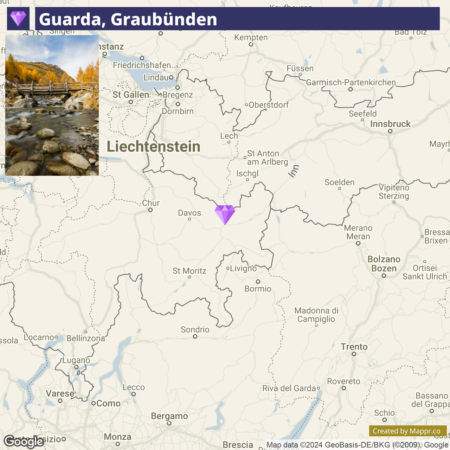 A map highlighting the location of Guarda, Graubünden, with a purple marker indicating its position in the region. Nearby geographical features and cities such as Chur, St. Moritz, and Davos are visible, as well as parts of Liechtenstein to the north. The map is annotated with names of towns and terrain features, and the Google Maps and Mappar.co attributions are displayed at the bottom.