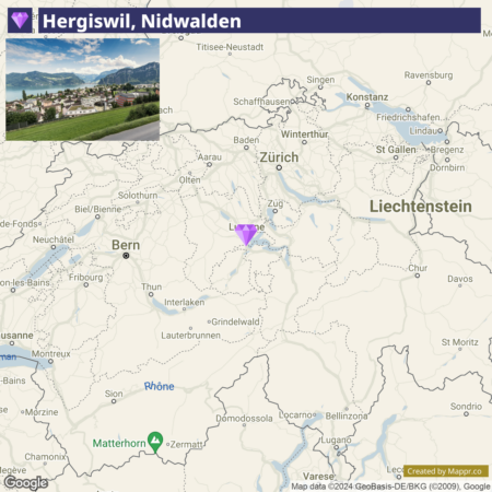 A map of part of Switzerland showing various cities and geographic features, with a focus box on Hergiswil in the canton of Nidwalden, including a landscape picture of Hergiswil inset in the upper left corner.