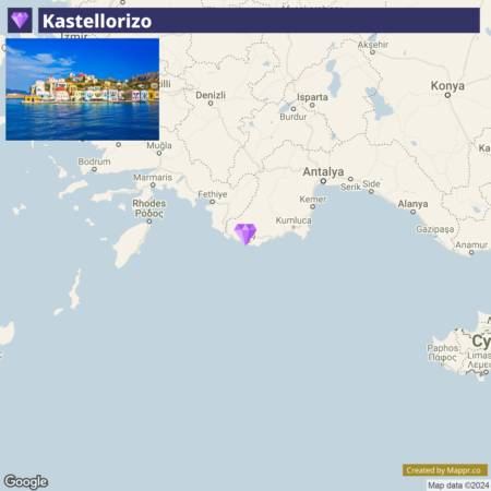 Map showing the geographic location of Kastellorizo in relation to surrounding areas, with a photograph of colorful buildings along a waterfront inset in the upper left corner. The map includes cities such as Antalya, Marmaris, and Rhodes, and has a pin marking the position of Kastellorizo.