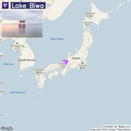 A map highlighting Lake Biwa in Japan with an inset picture of a traditional torii gate in a body of water at sunset.