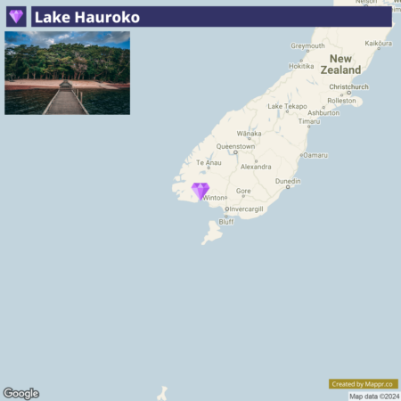 A wooden jetty stretching out into Lake Hauroko with surrounding forest, above a map of the southern region of New Zealand highlighting the location of Lake Hauroko.