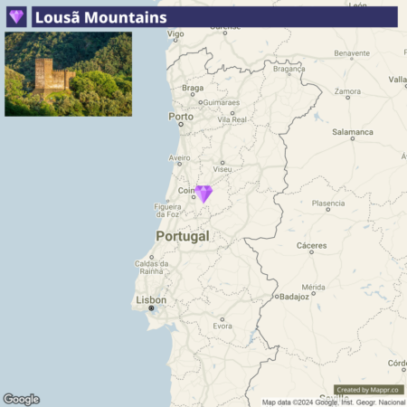 A snapshot from an interactive map highlighting the Lousã Mountains in Portugal with a purple diamond marker, accompanied by an inset image of a stone tower amidst lush greenery in the mountainous terrain.