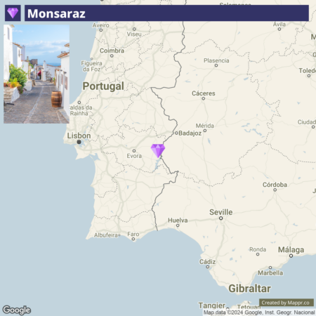 A map showing the location of Monsaraz in Portugal with a purple pin near the city of Evora, and other nearby Portuguese and Spanish cities labeled.