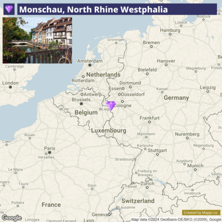 A map highlighting the location of Monschau in North Rhine-Westphalia, Germany, with nearby countries, cities, and state boundaries visible. There is also an inset photo in the top left corner showing a picturesque view of half-timbered houses alongside a river in Monschau.