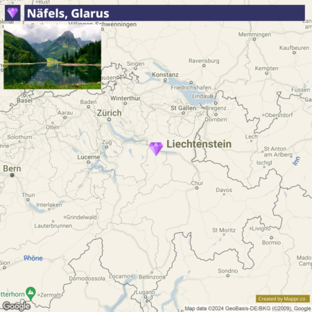 A map focusing on Näfels, Glarus in Switzerland with a location pin and an inset landscape photo of a lake and surrounding mountains. Nearby cities like Zurich and Lucerne are visible, as well as the neighboring country Liechtenstein.