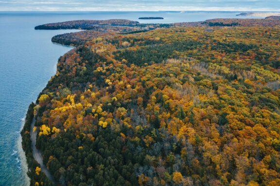Aerial View of a Forested Peninsula During Autumn Aerial view of peninsula state park during autumn season in Wisconsin.