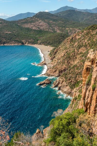 The dramatic red cliffs and azure waters of Piana Calanques