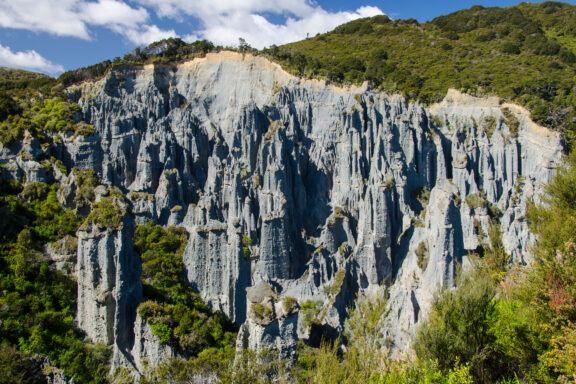 The sculpted forms of Putangirua Pinnacles against Wairarapa's rugged terrain