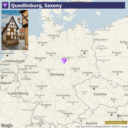 A map of Germany showing the location of Quedlinburg, Saxony, with a purple diamond marker. The picture in the left corner shows a traditional half-timbered house representative of Quedlinburg's architecture.