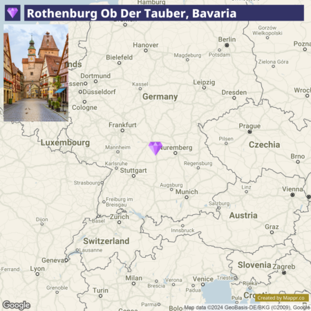 A Google map highlighting Rothenburg ob der Tauber in Bavaria, Germany, with a purple diamond marker, indicating its location within Europe. The map shows nearby major cities and country borders.