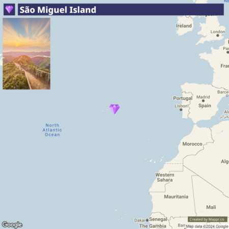 Map showing the location of São Miguel Island in the North Atlantic Ocean with an inset picture of a scenic sunset view from a mountain trail on the island.