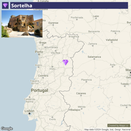 An image of a digital map displaying a section of the Iberian Peninsula, predominantly showing Portugal and parts of Spain. In the upper portion, there is a banner with the name "Sortelha" and a photo of an ancient stone building in an old village. A purple diamond shape highlights a location near the center of Portugal on the map.