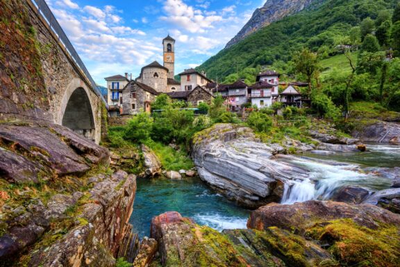 Traditional stone houses and a church within Valle Verzasca