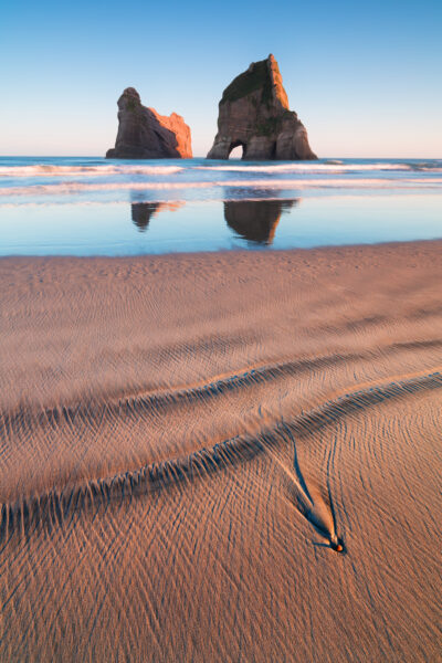 Wharariki Beach's dramatic archways and dunes in Golden Bay