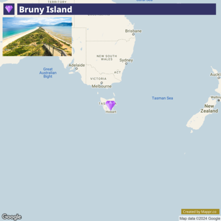 A map highlighting Bruny Island's location with an inset photograph of a coastal scene from the island, showing a sandy beach and vegetation with a wooden walkway. Bruny Island is marked near Hobart off the coast of Tasmania, Australia.