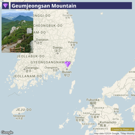 Map showing the location of Geumjeongsan Mountain in South Korea, with a purple heart marker indicating the mountain's position near Busan on the southeastern coast. The map includes names of various South Korean cities and provinces as well as part of the coastline of Japan.