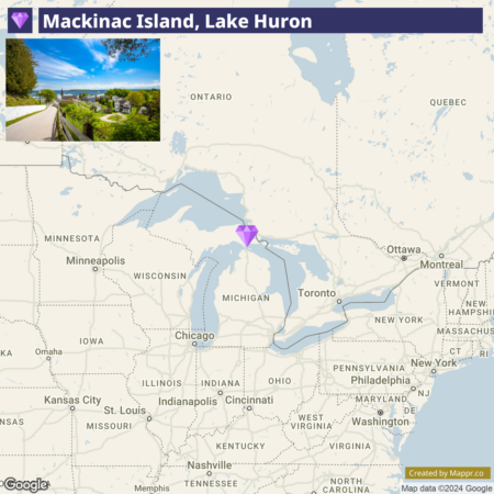 "Image showing a map with Mackinac Island, Lake Huron marked with a purple pin, along with surrounding states and major cities. A small inset photo at the top left depicts a scenic view of a pathway on Mackinac Island."