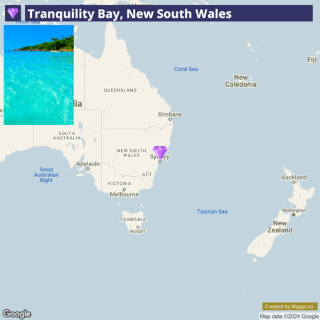 A map highlighting the location of Tranquility Bay in New South Wales, Australia, with an inset photograph showing a picturesque view of the clear turquoise waters and the lush coastline of the bay.