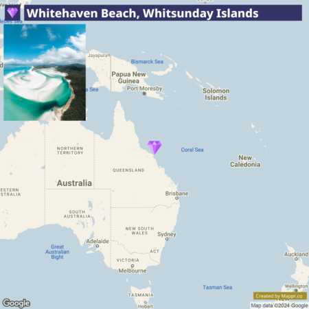 A map highlighting the location of Whitehaven Beach in the Whitsunday Islands, with an inset aerial photo of the beach in the upper left corner. The map shows the eastern coast of Australia and parts of the surrounding countries and bodies of water.