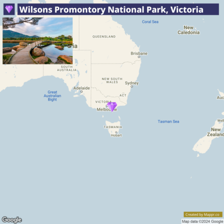 A map highlighting Wilsons Promontory National Park in Victoria, Australia, with an inset image showcasing a scenic view of the park with reflective waters and boulders.